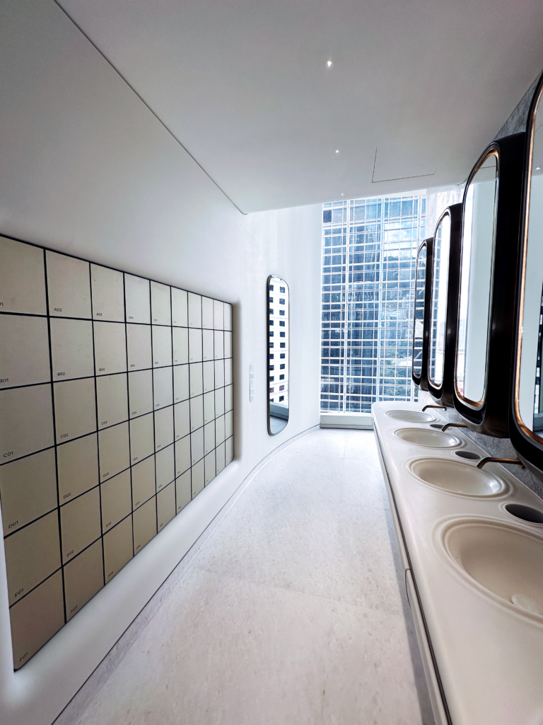 the toilet's walls and floors are laid with light-colored tiles to match the building’s overall color tone.